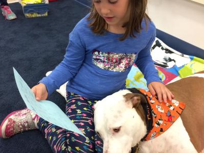 picture of therapy dog and student